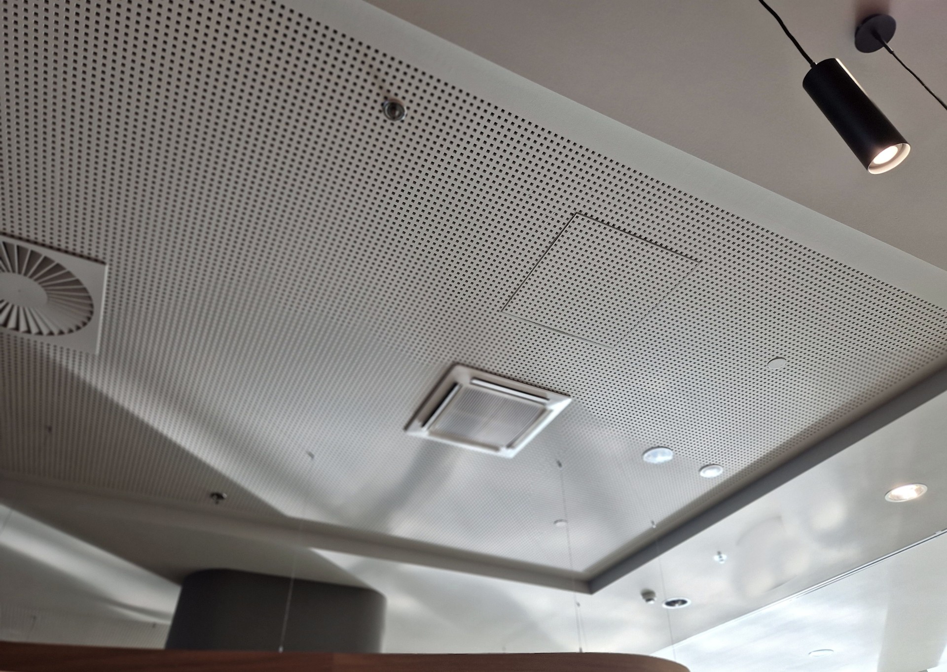 perforated plasterboard ceiling panels shatter echo in a large hall with tiled floor. entrance hall in a hotel where sounds must be muffled, press, surround sound